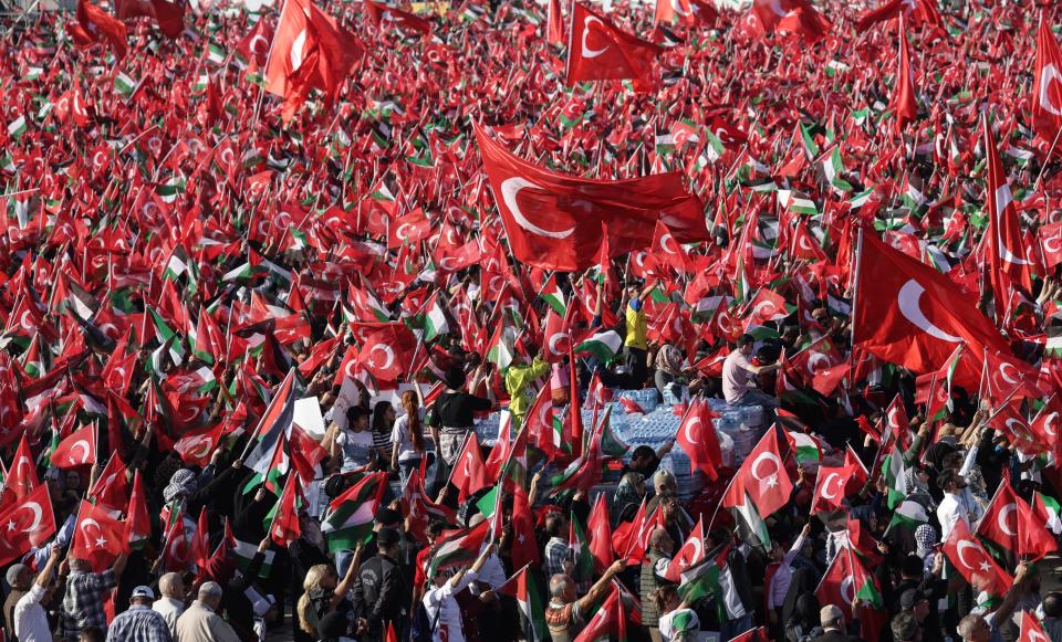 Supporters of Turkish President Recep Tayyip Erdogan hold Turkish and Palestinian flags during a pro-Palestinian rally at the Ataturk Airport in Istanbul (EPA)