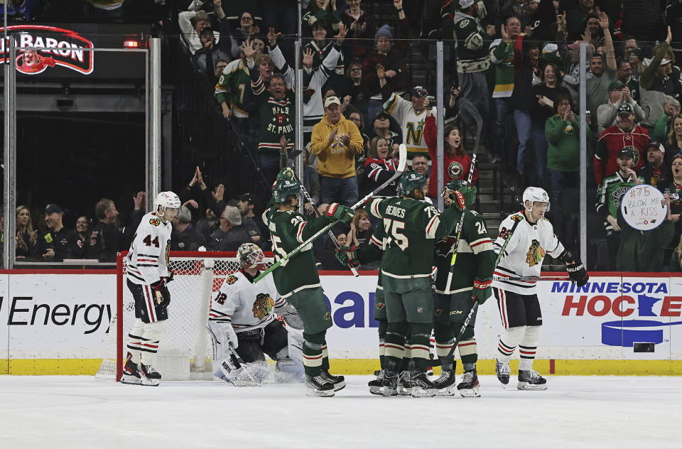 Minnesota Wild right wing Ryan Reaves (75) celebrates with teammates after scoring a goal against the Chicago Blackhawks during the second period of an NHL hockey game Saturday, March 25, 2023, in St. Paul, Minn. (AP Photo/Stacy Bengs)