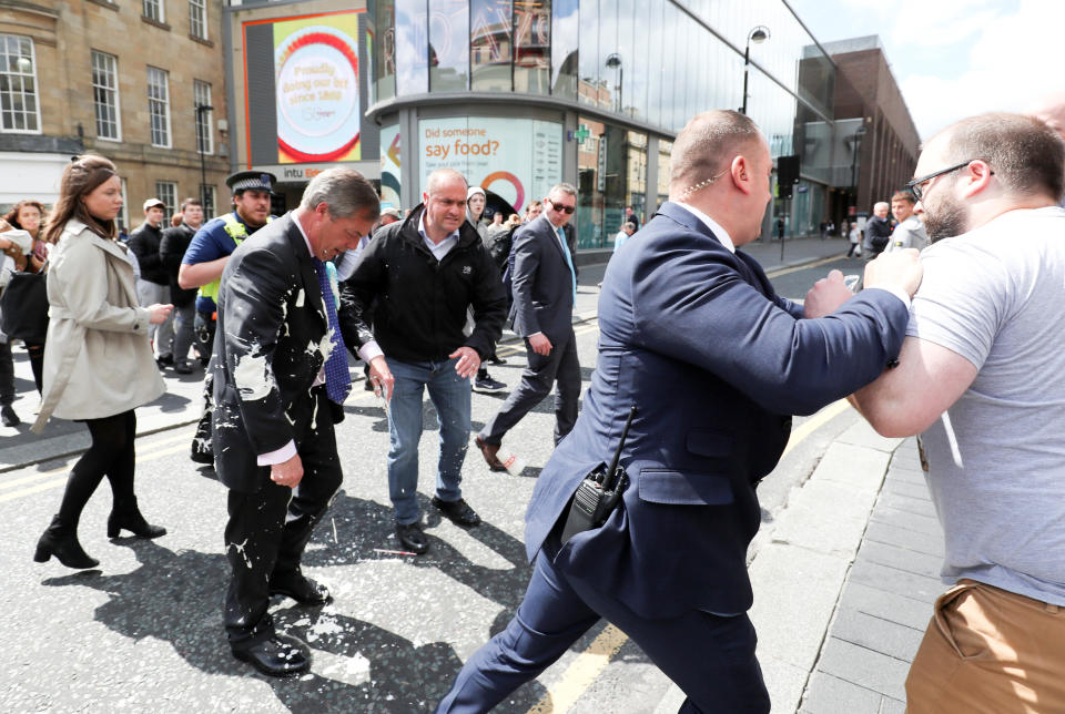 Brexit Party leader Nigel Farage gestures after being hit with a milkshake while arriving for a Brexit Party campaign event in Newcastle, Britain, May 20, 2019. REUTERS/Scott Heppell