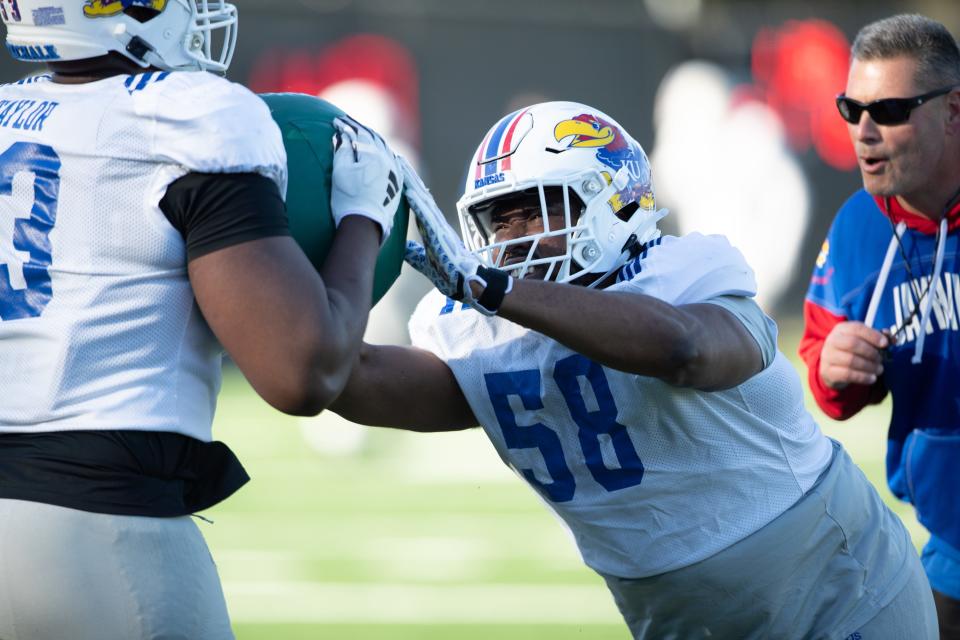 Kansas redshirt senior defensive tackle Javier Derritt (58) works through drills during an outdoor practice in early April in Lawrence.