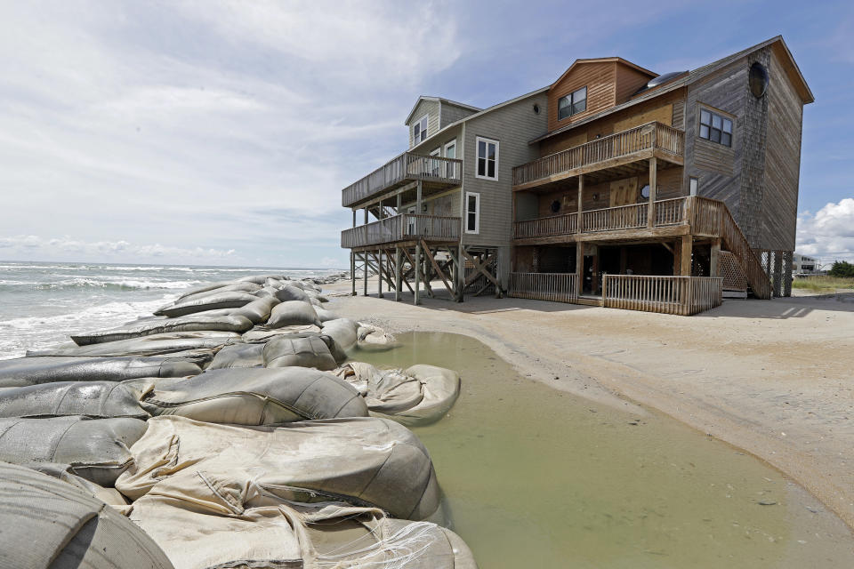 Sand bags surround homes on North Topsail Beach, N.C., Wednesday, Sept. 12, 2018 as Hurricane Florence threatens the coast. (AP Photo/Chuck Burton)