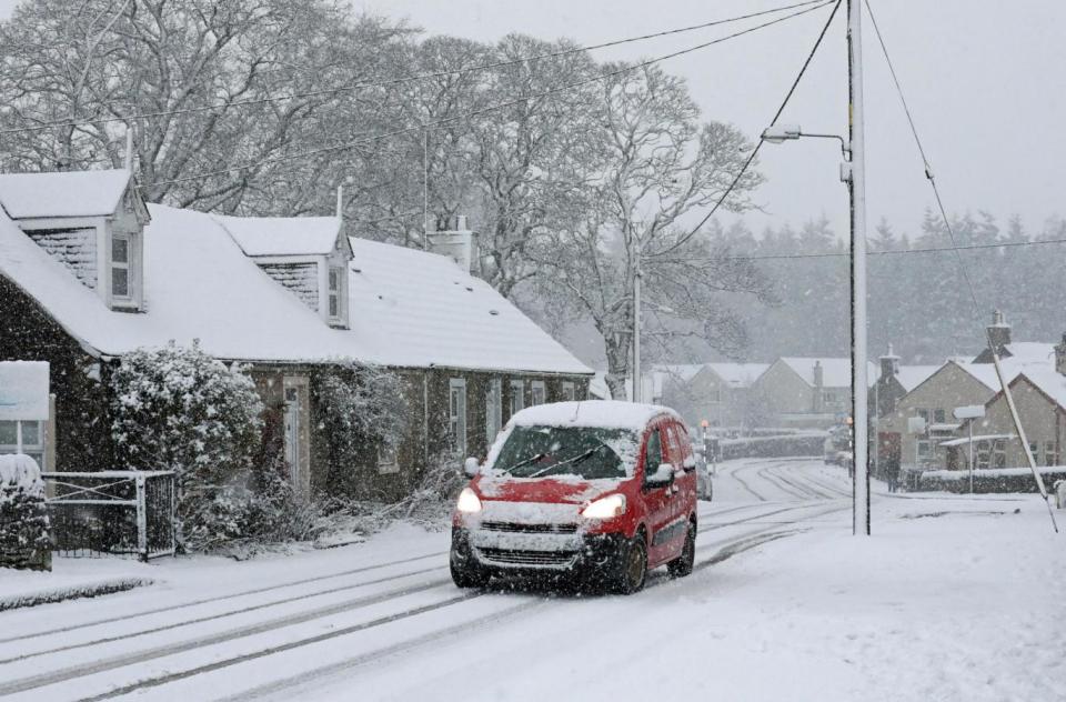 A Royal Mail van battles through snowy conditions in Braco, Perthshire (PA)