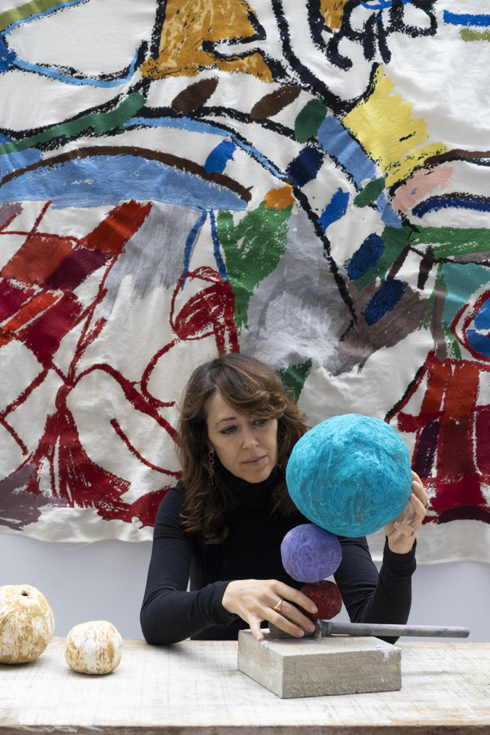 Here and above: Annie Morris in her London studio with works in progress. The spheres that resemble potatoes have yet to be painted.