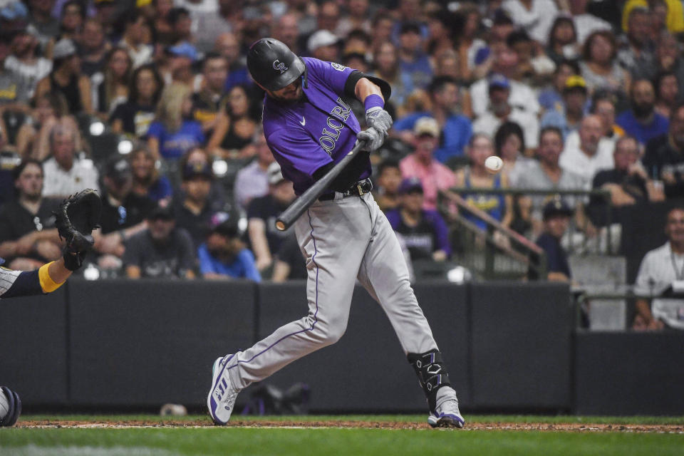 Colorado Rockies' Kris Bryant hits a ball to the infield, reaching first on an error by Milwaukee Brewers third baseman Luis Urias during the sixth inning of a baseball game Saturday, July 23, 2022, in Milwaukee. (AP Photo/Kenny Yoo)