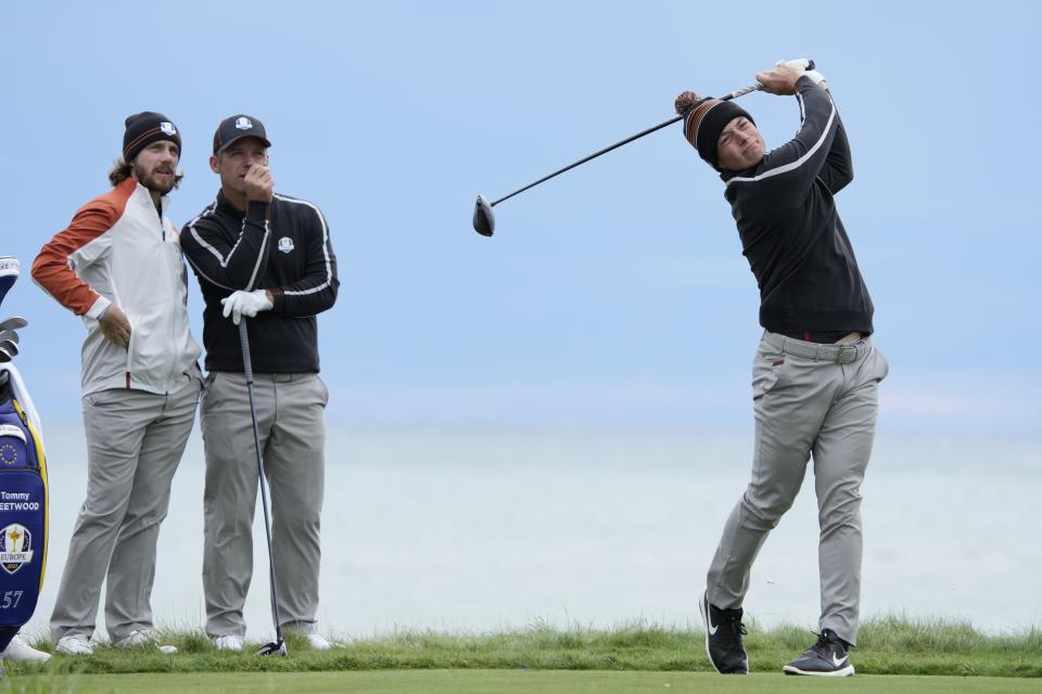 Team Europe's Tommy Fleetwood and Team Europe's Paul Casey watch the drive of Team Europe's Viktor Hovland during a practice day at the Ryder Cup at the Whistling Straits Golf Course Thursday, Sept. 23, 2021, in Sheboygan, Wis. (AP Photo/Ashley Landis)