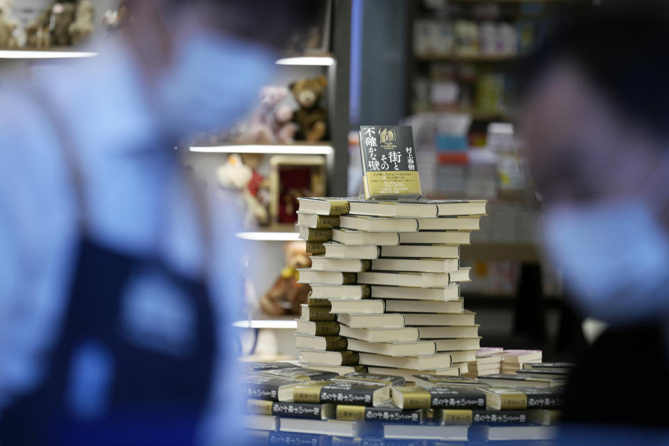 Shop clerks prepare to sell Japanese writer Haruki Murakami's new novel "The City and Its Uncertain Walls" on the first day for sale at Kinokuniya bookstore in Shinjuku district early Thursday, April 13, 2023, in Tokyo. (AP Photo/Eugene Hoshiko)