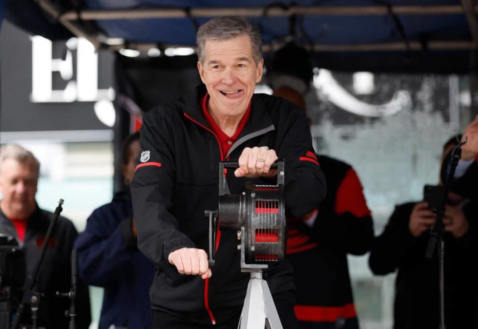 N.C. Governor Roy Cooper prepares to crank the warning siren to kickoff the Carolina Hurricanes Fan Fest in downtown Raleigh Friday, Feb. 17, 2023. The festival is part of the celebrations before the Carolina Hurricanes’ Stadium Series outdoor game against the Washington Capitals Saturday at Carter-Finley Stadium.