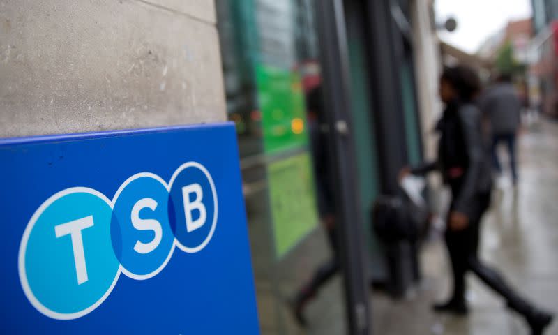FILE PHOTO: A woman wlalks into a branch of TSB bank in London