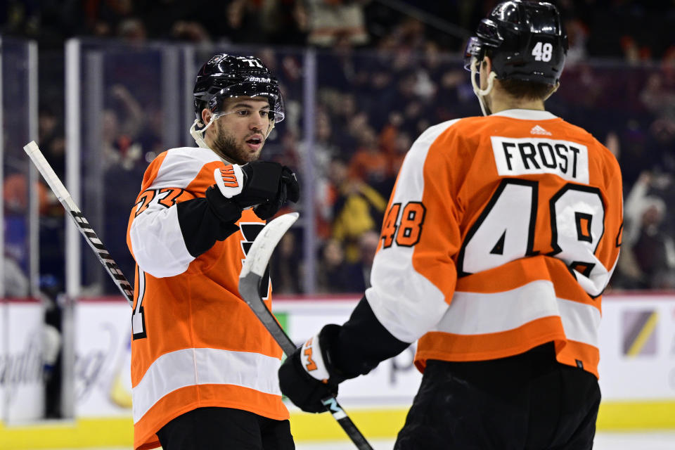 Philadelphia Flyers' Tony DeAngelo, left, celebrates his goal with Morgan Frost (48) during the second period of an NHL hockey game against the Colorado Avalanche, Monday, Dec. 5, 2022, in Philadelphia. (AP Photo/Derik Hamilton)