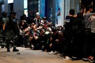 Riot police detain anti-government protesters in a large scale during a legal demonstration on the New Year's Day to call for better governance and democratic reforms in Hong Kong