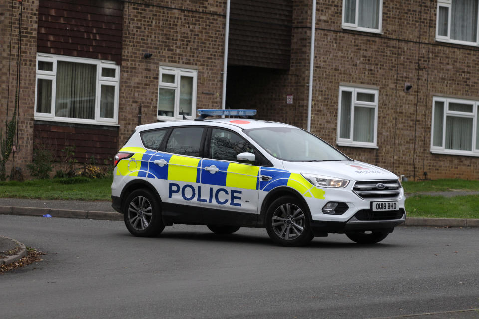 Police outside the flat in Yaxley, Cambridgeshire, where newborn Reuben McNulty was attacked by two dogs (SWNS)