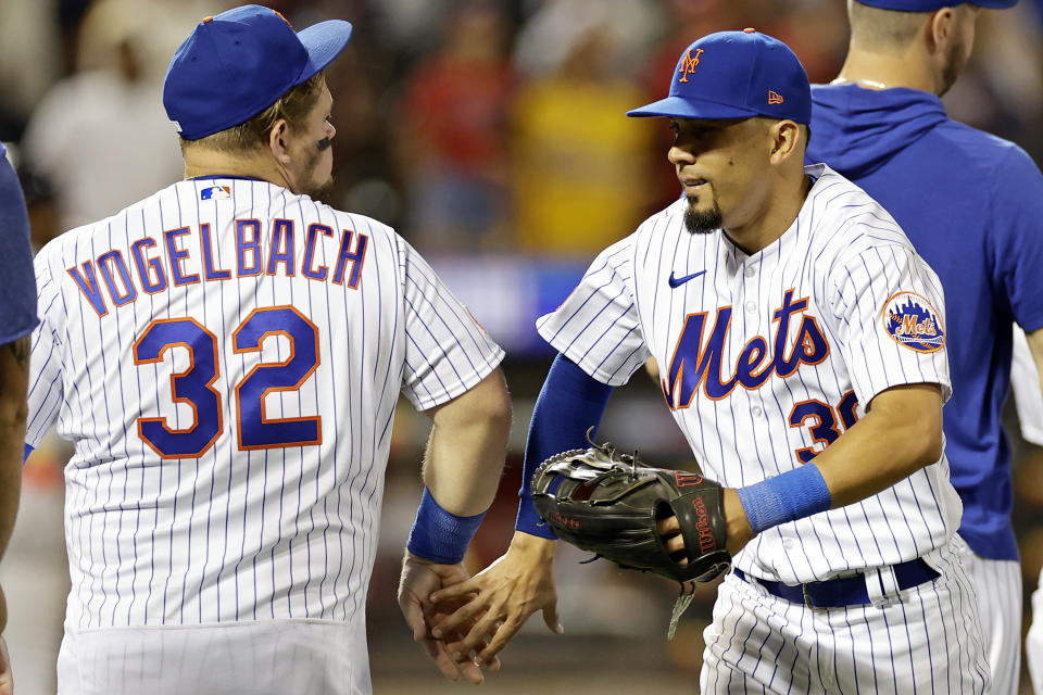 New York Mets center fielder Rafael Ortega, right, and Daniel Vogelbach (32) celebrate after the Mets defeated the Atlanta Braves in a baseball game on Sunday, Aug. 13, 2023, in New York. (AP Photo/Adam Hunger)