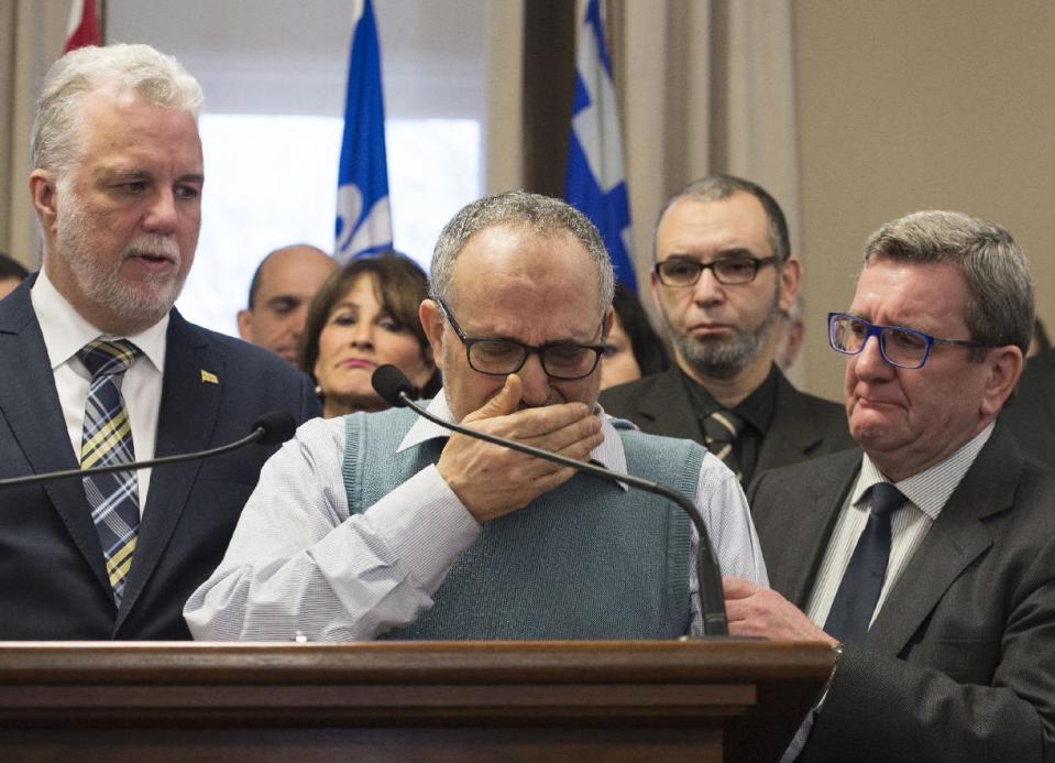 CORRECTS NAME AND TITLE TO LABIDI FROM LABIBI AND VICE PRESIDENT FROM PRESIDENT - Mohamed Labidi, the vice-president of the mosque where an attack happened, is comforted by Quebec Premier Philippe Couillard, left, and Quebec City mayor Regis Labeaume, right, during a news conference Monday, Jan. 30, 2017, about the fatal shooting at the Quebec Islamic Cultural Centre on Sunday. Prime Minister Justin Trudeau and Couillard both characterized the attack at the mosque during evening prayers as a terrorist act. (Jacques Boissinot/The Canadian Press via AP)