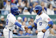 Kansas City Royals' Nelson Velázquez (17) is congratulated at home plate by Kyle Isbel (28) after scoring off a two-run single by Hunter Renfroe (16) during the fifth inning of a baseball game against the Texas Rangers in Kansas City, Mo., Saturday, May 4, 2024. (AP Photo/Colin E. Braley)