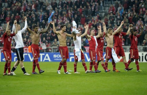 Bayern Munich's players celebrate after their UEFA Champions League 2nd leg quarter-final match vs Olympique de Marseille, in Munich, southern Germany, on April 3. Having reached the Champions League semis, Bayern turn their attention back to the German league and resurgent Augsburg as they look to attack Borussia Dortmund's three-point lead