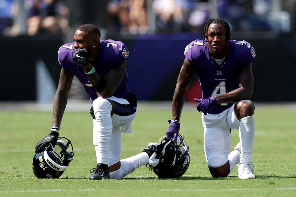 Rashod Bateman and Zay Flowers of the Baltimore Ravens take a knee after a referee collapses on the field. (Photo by Rob Carr/Getty Images)