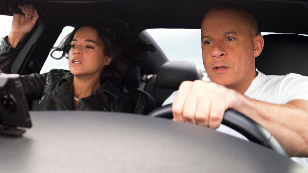  Michelle Rodriguez in the passenger seat and Vin Diesel driving in F9. 