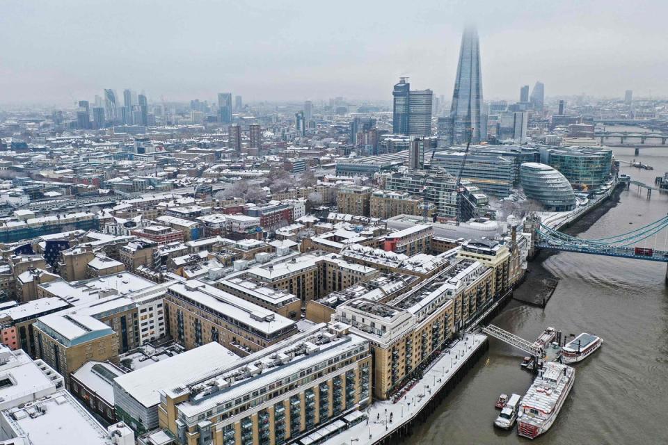 An aerial view shows snow-covered offices and buildings including the Shard skyscraper on the south bank of the River Thames (AFP via Getty Images)