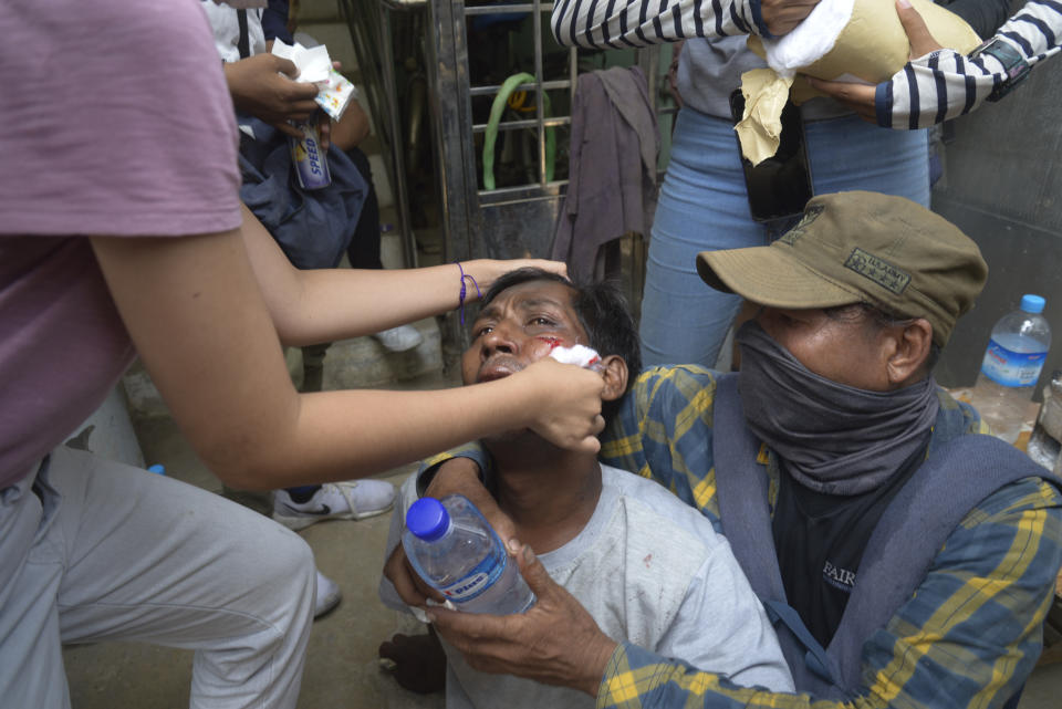 Anti-coup protesters attend to an injured rallyist during a demonstration in Yangon, Myanmar on Tuesday March 30, 2021. Thailand’s Prime Minister Prayuth Chan-ocha denied Tuesday that his country’s security forces have sent villagers back to Myanmar who fled from military airstrikes and said his government is ready to shelter anyone who is escaping fighting. (AP Photo)