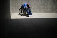 An inmate sits in the yard of a cellblock which mainly houses prisoners with cognitive decline, Alzheimer's, and dementia, at the California Health Care Facility in Stockton, California, U.S., May 24, 2018. REUTERS/Lucy Nicholson