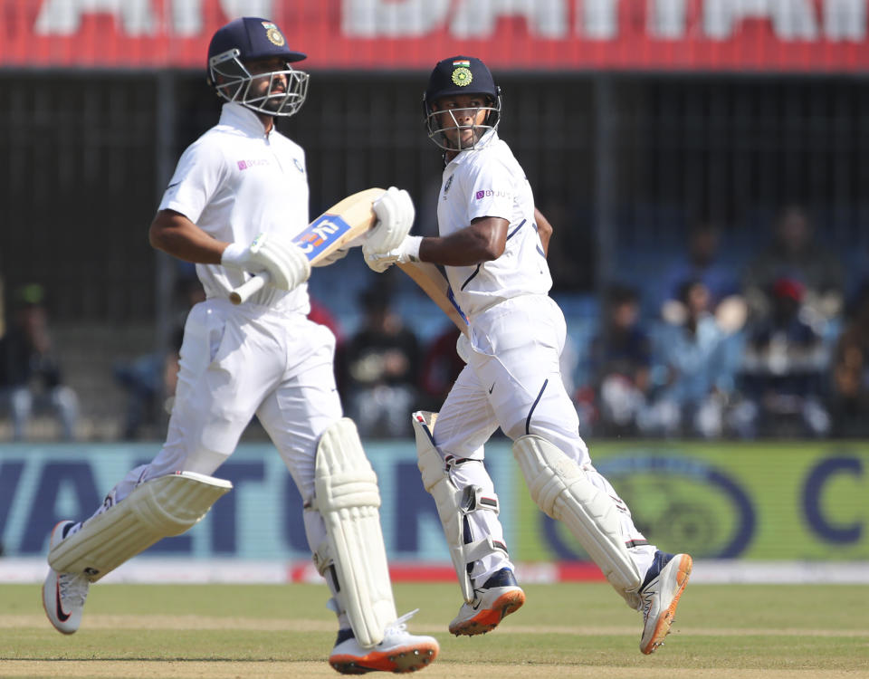 India's Mayank Agarwal, right, and batting partner Ajinkya Rahane run between the wickets to score during the second day of first cricket test match between India and Bangladesh in Indore, India, Friday, Nov. 15, 2019. (AP Photo/Aijaz Rahi)
