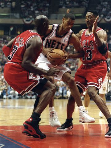 <p>Ezra Shaw/Getty</p> Kerry Kittles #30 of the New Jersey Nets in action against Michael Jordan #23 and Scottie Pippen #33 of the Chicago Bulls during the NBA Playoffs in 1998