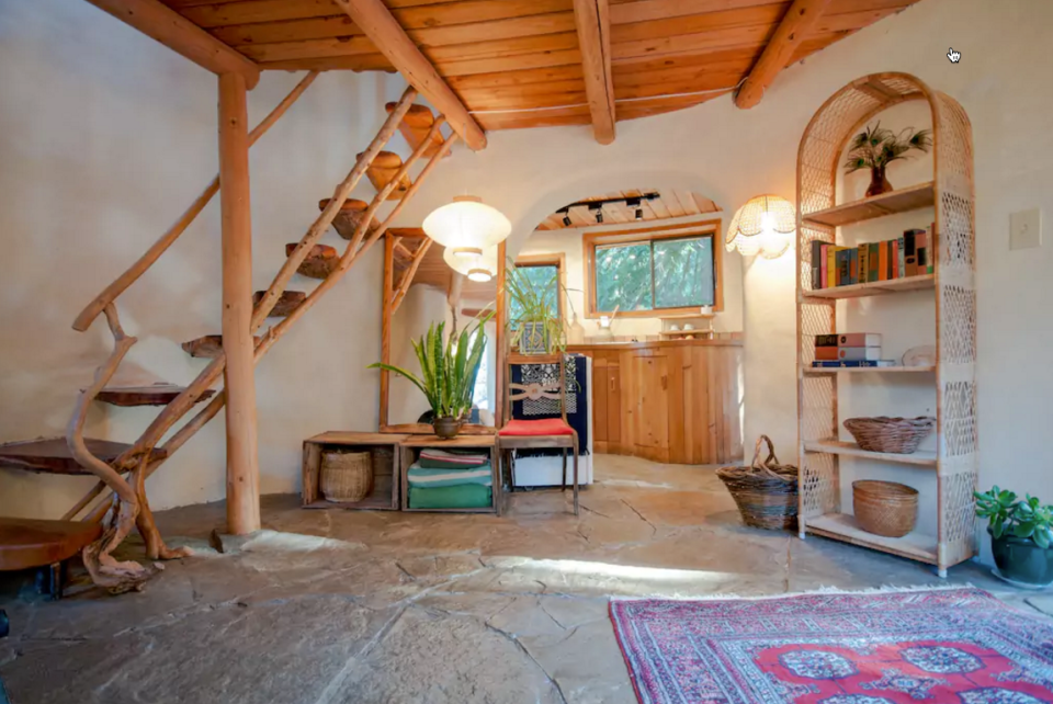 <p>The cozy two-storey cabin has stone floors, wood panelling (Airbnb) </p>