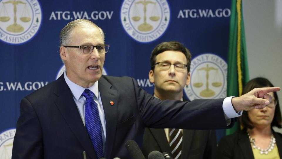 Washington Gov. Jay Inslee, left, talks to reporters as Washington Attorney General Bob Ferguson, right, looks on, Monday, Jan. 30, 2017, in Seattle. Ferguson announced that he is suing President Donald Trump over an executive order that suspended immigration from seven countries with majority-Muslim populations and sparked nationwide protests. (AP Photo/Ted S. Warren)