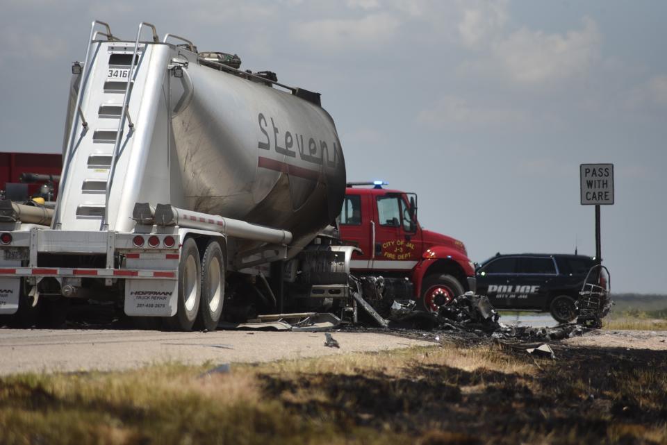 Grass along New Mexico State Route 128 near Jal shows burn marks following a fatal head-on crash Thursday, July 11, 2019. Authorities say four oilfield workers traveling in a pickup truck and the driver of a big rig were pronounced dead at the scene. (Jason Farmer/The Hobbs Daily News-Sun via AP)