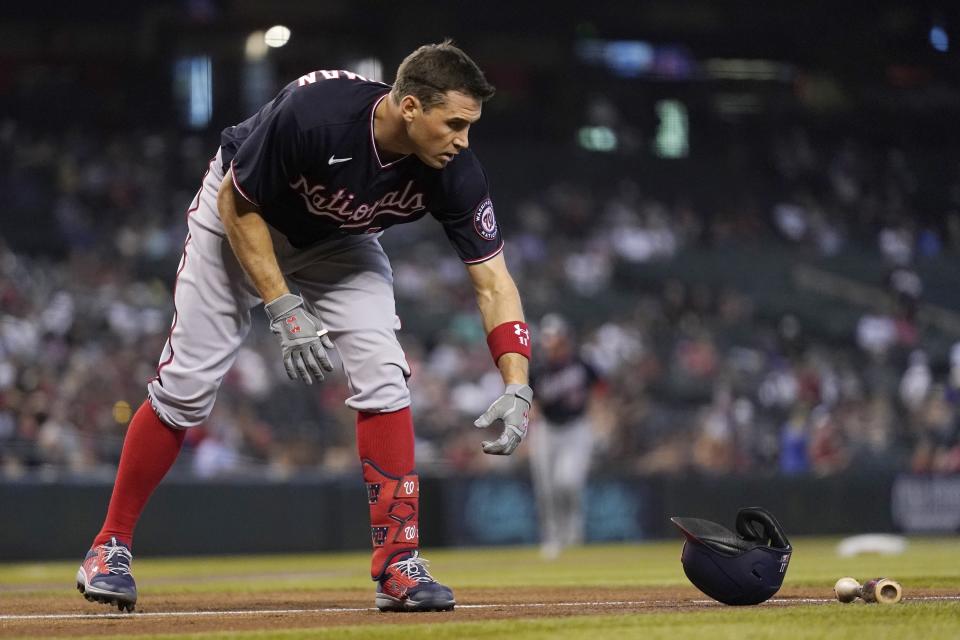 Washington Nationals' Ryan Zimmerman tosses his helmet down after striking out against the Arizona Diamondbacks during the first inning of a baseball game Sunday, May 16, 2021, in Phoenix. (AP Photo/Ross D. Franklin)