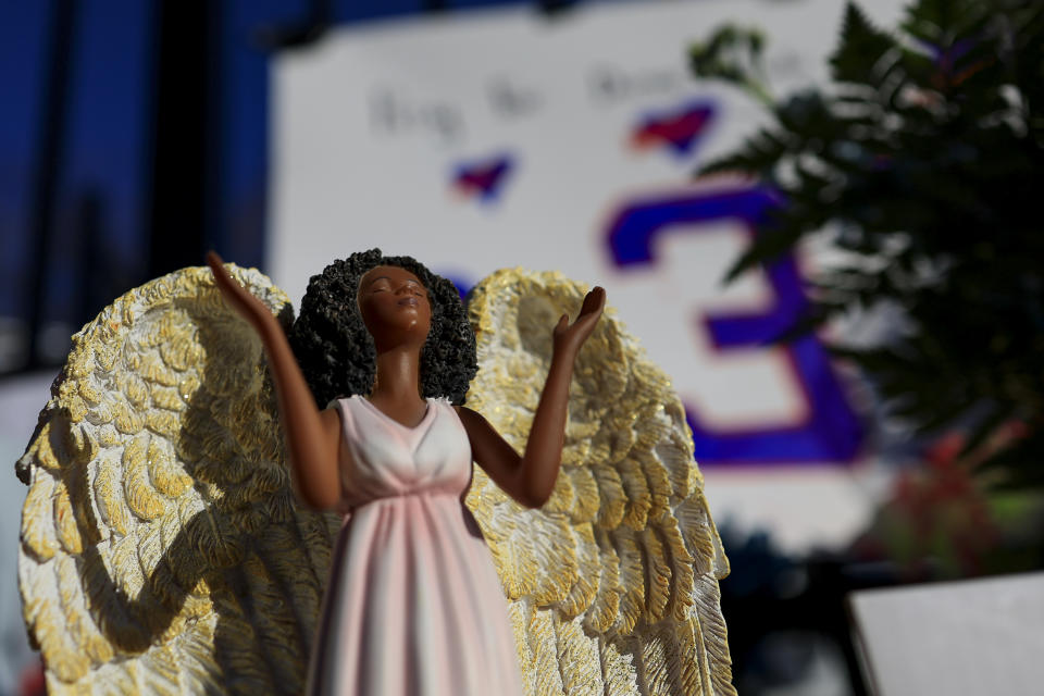 A figurine of an angel stands at the display set up for Buffalo Bills' Damar Hamlin outside of University of Cincinnati Medical Center, Wednesday, Jan. 4, 2023, in Cincinnati. Hamlin was taken to the hospital after collapsing on the field during the Bill's NFL football game against the Cincinnati Bengals on Monday night. (AP Photo/Aaron Doster)