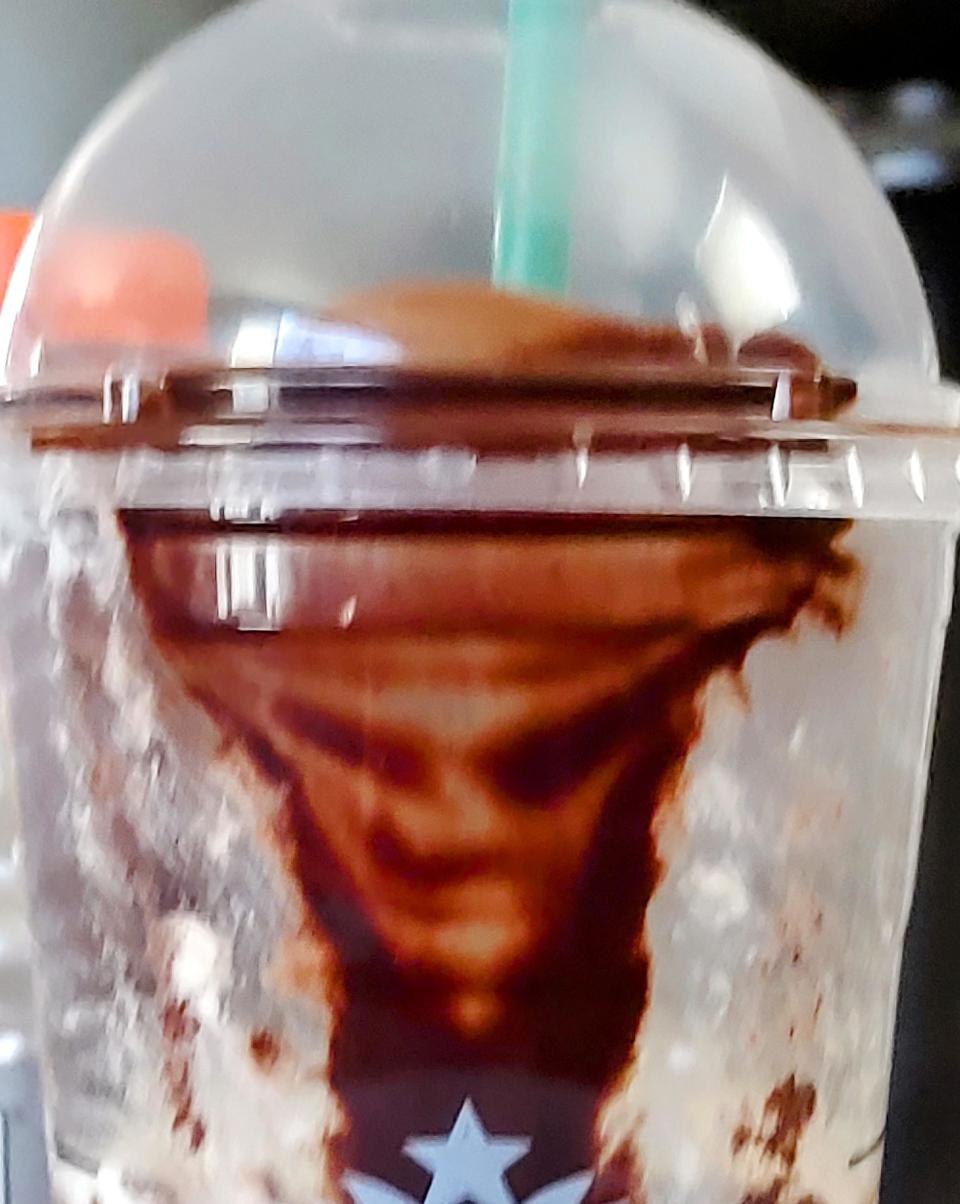 A face in someone's drink