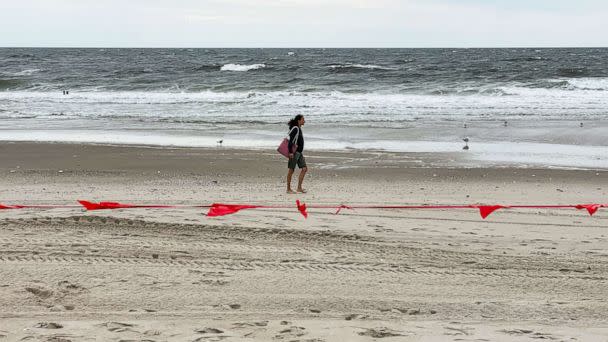 PHOTO: A person walks by the ocean in Rockaway Beach during Labor Day Weekend, Sept. 5, 2021, in New York. (Noam Galai/Getty Images)