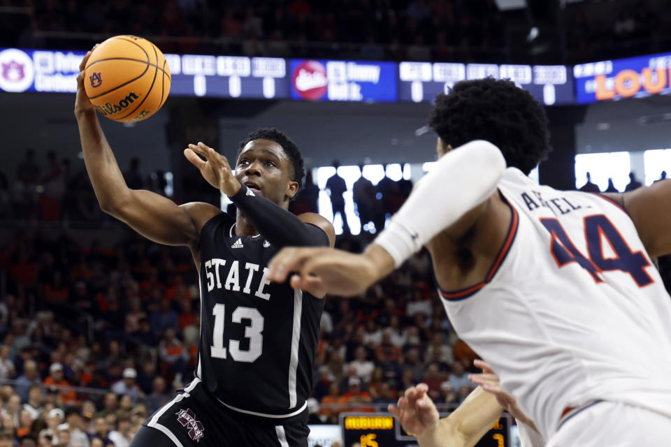 Mississippi State guard Josh Hubbard (13) drives to the basket around Auburn center Dylan Cardwell (44) during the first half of an NCAA college basketball game, Saturday, March 2, 2024, in Auburn, Ala. (AP Photo/ Butch Dill)