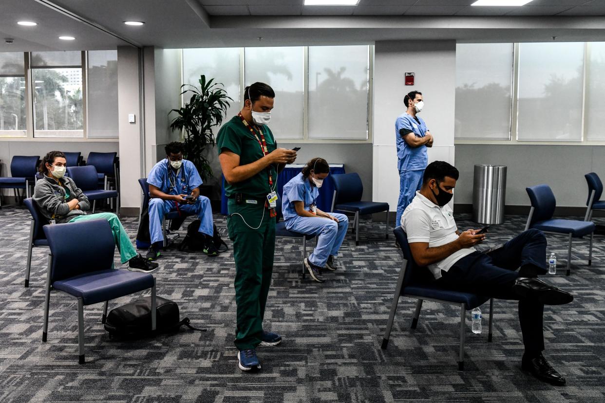 Students and doctors of Medical Science listen to the governor of Florida during a press conference to address the rise of coronavirus cases in the state at Jackson Memorial Hospital in Miami on July 13, 2020. Virus epicenter Florida saw 12,624 new cases on July 12, the second highest daily count recorded by any state, after its own record of 15,300 new COVID-19 cases a day earlier.