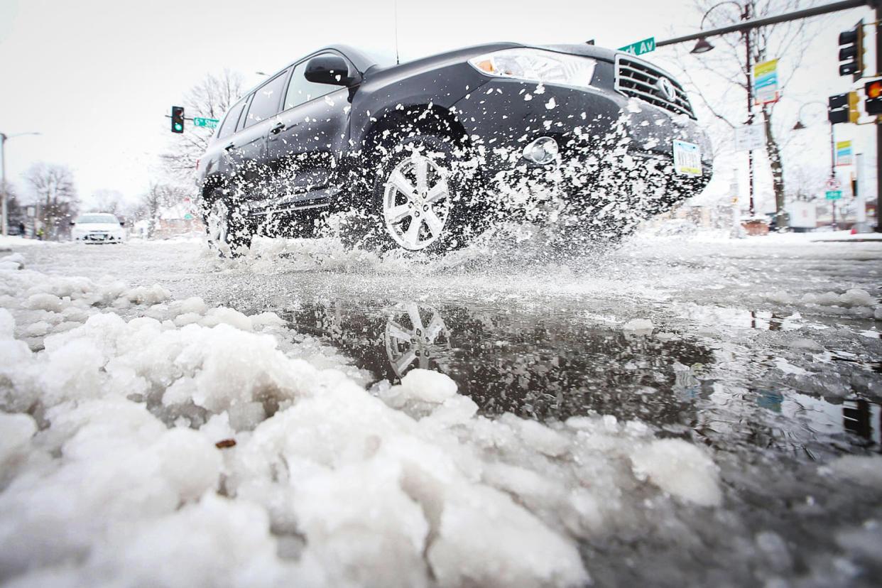 A car passes through snow on Clark Avenue after a snowstorm  (Nirmalendu Majumdar / USA Today Network)