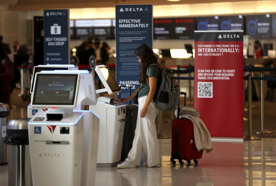 A Delta customer checks in for a flight at San Francisco International Airport on May 12, 2022.