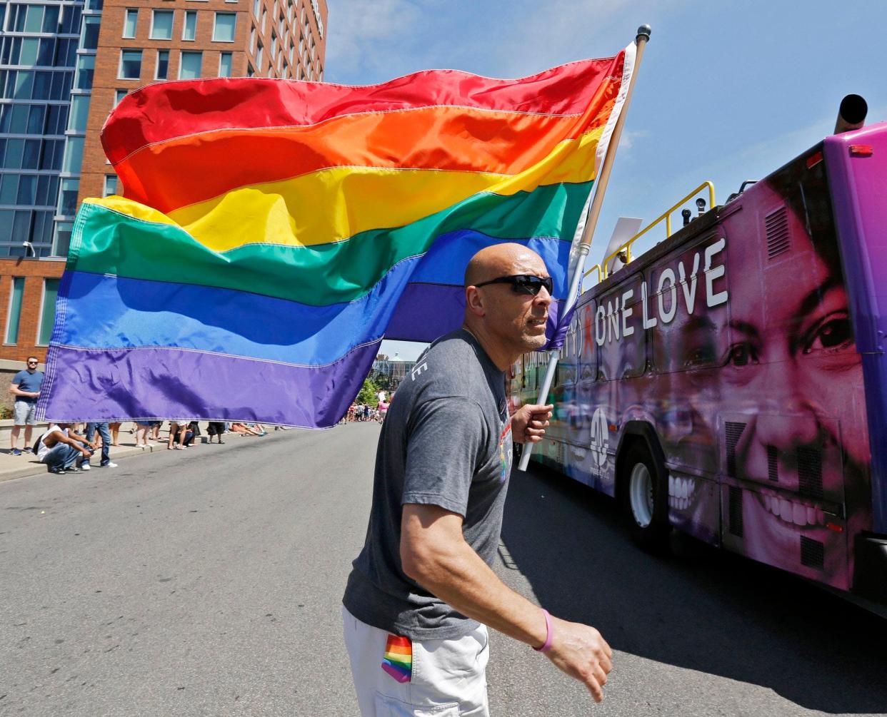 The rainbow flag has been used as a symbol of the LGBTQ+ gay community since the late 1960s. Charles Thomas is seen here carrying a rainbow flag while walking up High Street with Battelle Prism during the Columbus Pride parade on June 18, 2016. Big Walnut school board on Dec. 14 voted 3-2 to ban the rainbow flag from school grounds.