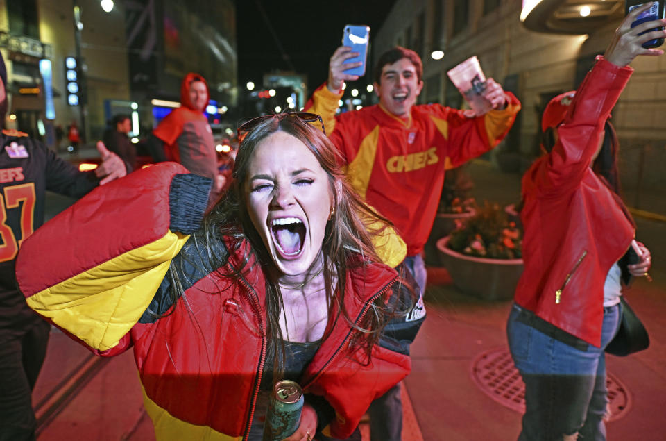 Kansas City Chiefs fans celebrate at the Power and Light District, late Sunday, Feb. 11, 2024, in Kansas City, Mo., after the Chiefs beat the San Francisco 49ers in the Super Bowl NFL football game in overtime. (AP Photo/Peter Aiken)