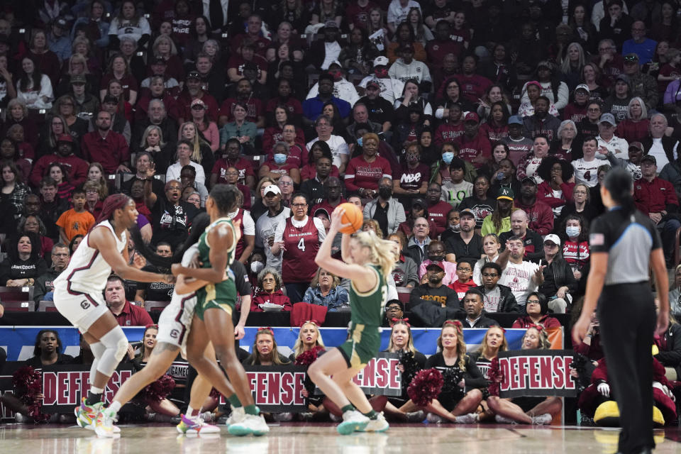 Basketball fans watch a women's second-round college basketball game between South Florida and South Carolina in the NCAA Tournament, Sunday, March 19, 2023, at Colonial Life Arena in Columbia, S.C. The NCAA changed the format of the women's tournament this year, featuring two regional sites instead of the traditional four. The games in Greenville, South Carolina and Seattle are the latest step to grow the sport and show the ladies can stand on their own. (AP Photo/Sean Rayford)