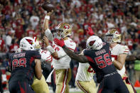 San Francisco 49ers quarterback Jimmy Garoppolo (10) gets the throw off as Arizona Cardinals outside linebacker Terrell Suggs (56) applies pressure during the first half of an NFL football game, Thursday, Oct. 31, 2019, in Glendale, Ariz. (AP Photo/Ross D. Franklin)