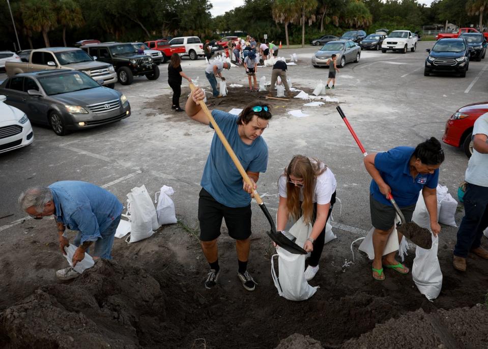 People fill sandbags at Helen Howarth Park as they prepare for the possible arrival of Hurricane Ian on September 26, 2022 in St Petersburg, Florida (Getty Images)