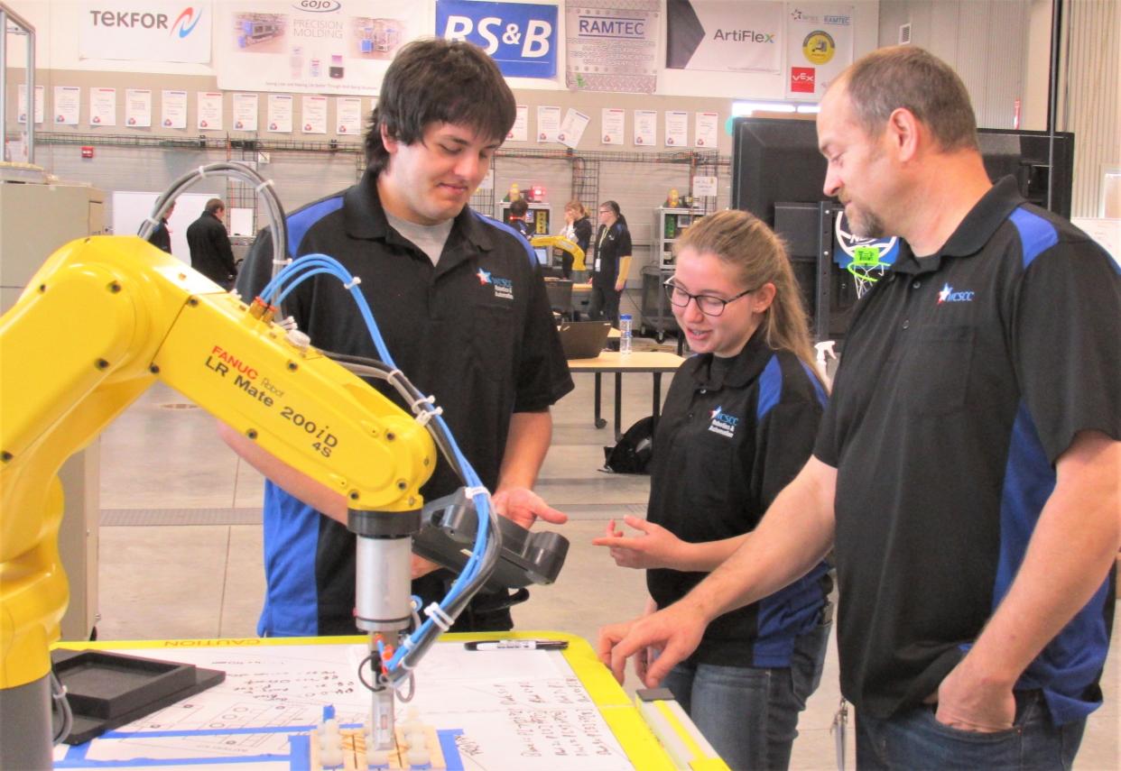 Evan Blough (left) and Lydia Styer discuss a robotics problem with instructor Drew Fuller. Blough and Styer will be representing the Wayne County Schools Career Center RAMTEC Program at the SkillsUSA State Championships May 3 in Columbus.