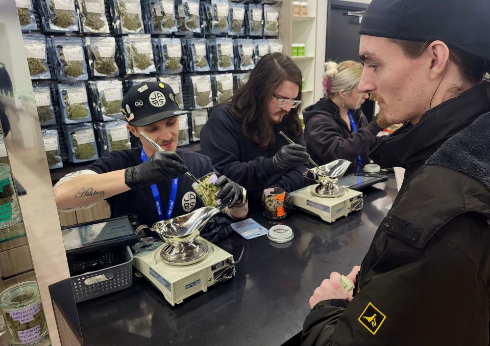 Resident Casey VanCamp watches on while JARS Cannabis floor leader Ryan Keil weighs some of the sales floor's flower on Wednesday, Jan. 17, 2024, at the downtown store. JARS is the first marijuana retailer to open in the city.