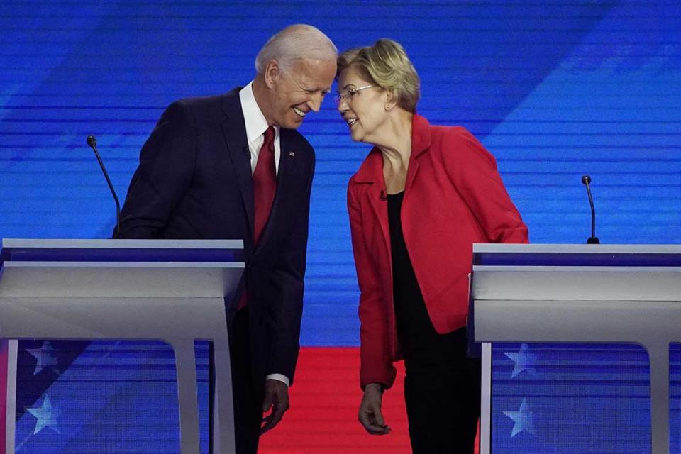 FILE - In this Sept. 12, 2019, file photo Democratic presidential candidates former Vice President Joe Biden, left and Sen. Elizabeth Warren, D-Mass., talk during a Democratic presidential primary debate hosted by ABC at Texas Southern University in Houston. Warren, a Massachusetts senator and leading progressive, has become an unlikely confidant and adviser to Biden, the presumptive Democratic presidential nominee. They talk every 10 days or so, according to aides to both politicians who requested anonymity to describe their relationship. (AP Photo/David J. Phillip, File)
