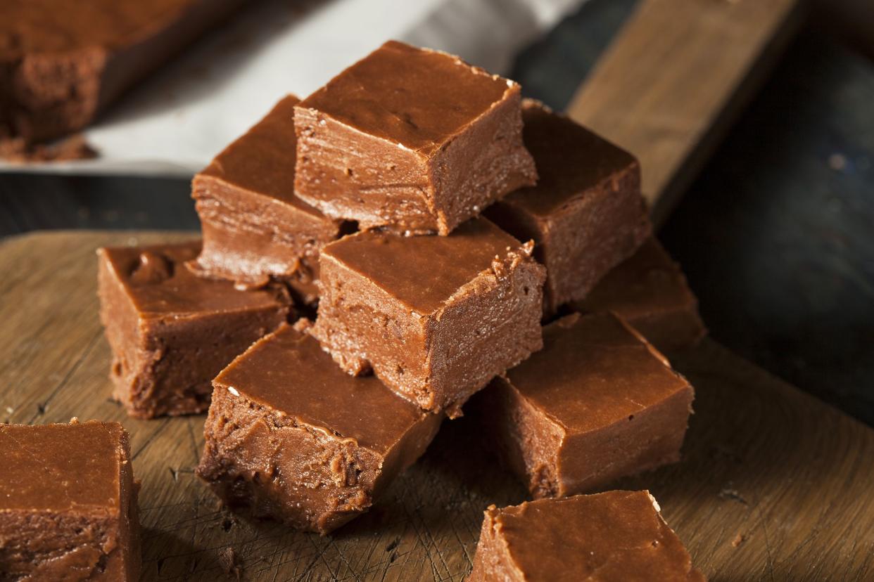 A pyramid of 3 minute fudge on a wooden server with a blurred background