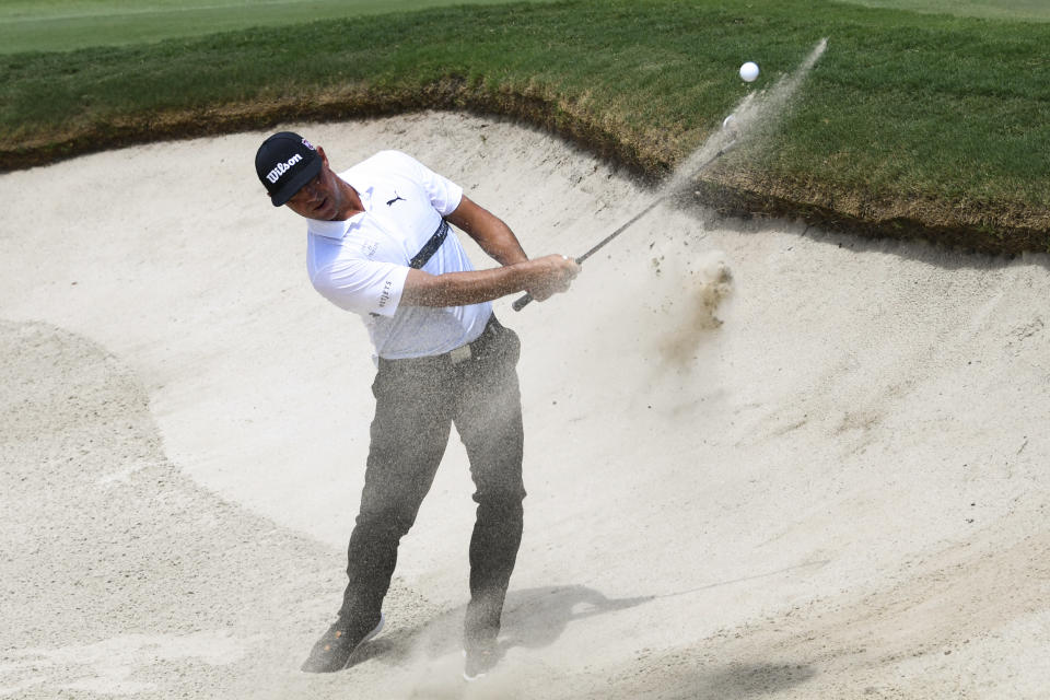 Gary Woodland hits out of a bunker to first green during the second round of the Tour Championship golf tournament Friday, Aug. 23, 2019, in Atlanta. (AP Photo/John Amis)