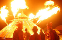 <p>Participants watch the flames of the mutant vehicle as approximately 70,000 people from all over the world gather for the 30th annual Burning Man arts and music festival in the Black Rock Desert of Nevada, Aug. 31, 2016. (REUTERS/Jim Urquhart)</p>