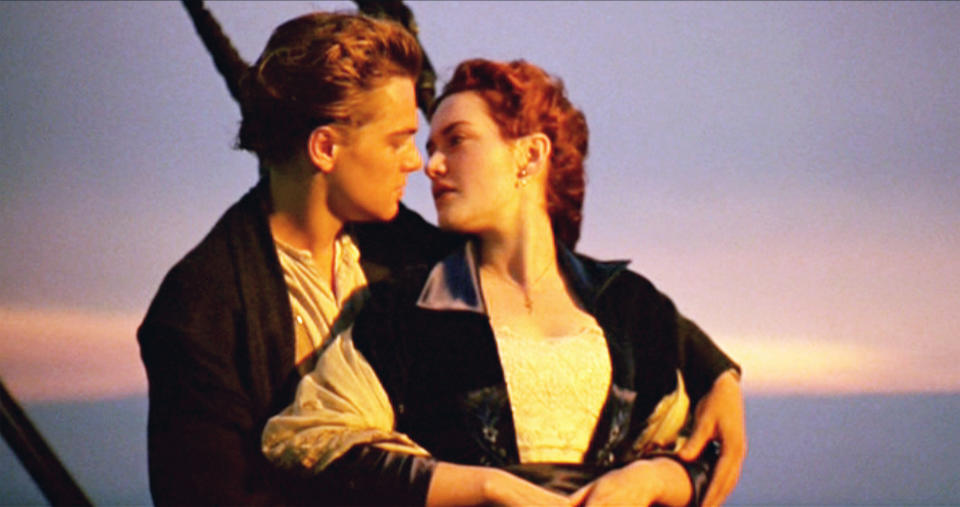 Leonardo DiCaprio as Jack and Kate Winslet as Rose stand at the front of the ship in "Titanic"