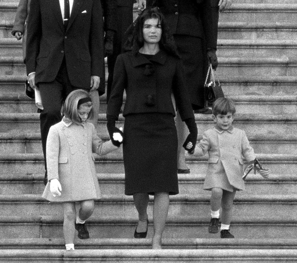 Jacqueline Kennedy walks down the Capitol steps with daughter Caroline and son John Jr. after President John F. Kennedy's casket was placed in the rotunda on Nov. 24, 1963.